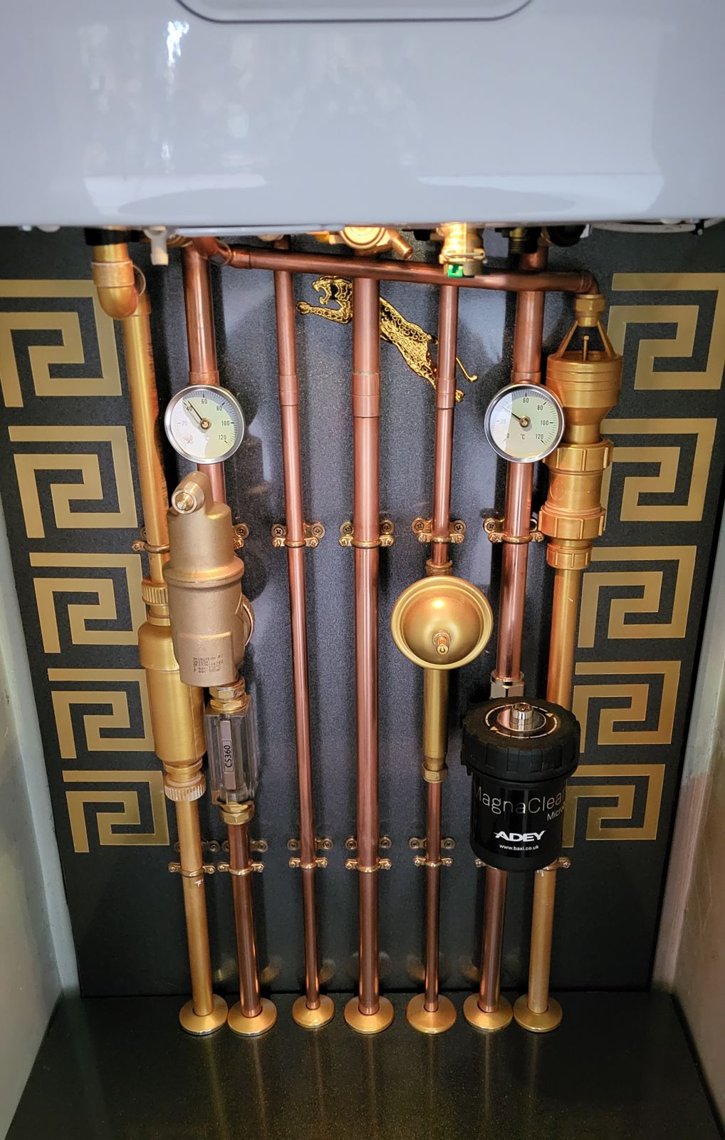 Copper pipework, gauges and magnetic filter below a new boiler in Milton Keynes