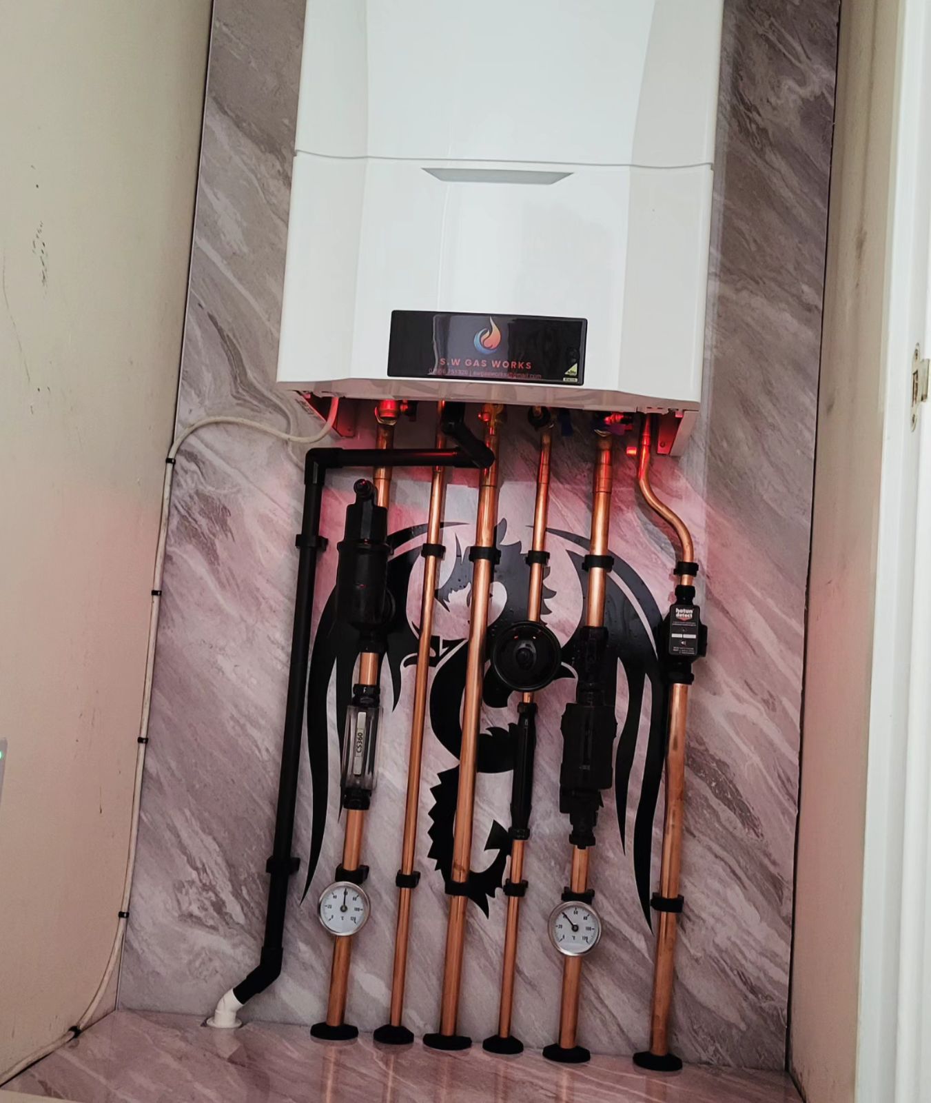 Baxi boiler fitted with labelled copper pipework and a magnetic filter in Rushden